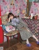 A woman sitting on a chair in front of a mirror.